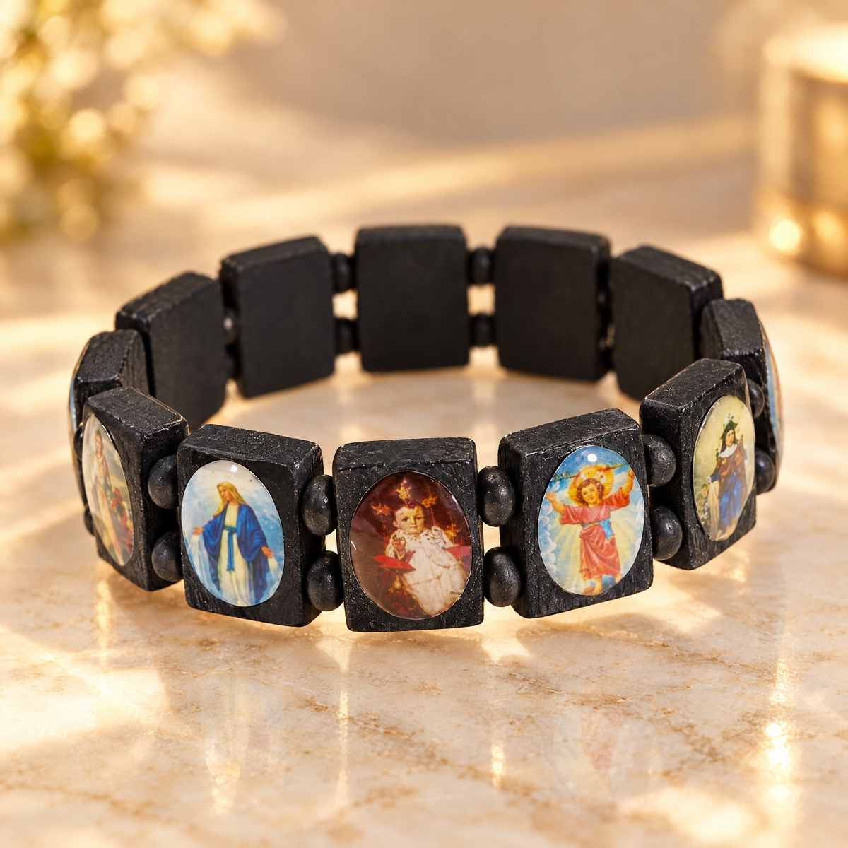 Black wooden saints rosary bracelet on cream marble